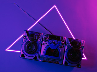 Audio cassette recorder with antenna. 80's synth wave and retrowave glowing triangle futuristic...