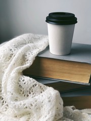 coffee cup to go standing on books 