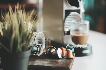 Espresso coffee capsules and Capsule coffee machines on white desk at office .selective focus