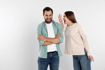 Couple quarreling on light background. Relationship problems