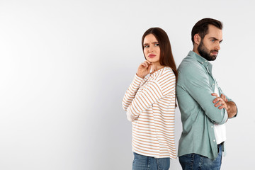 Couple with relationship problems on light background