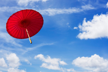 Red umbrella with clear blue sky background