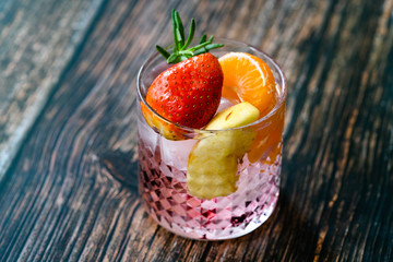 Fruit Cocktail with Strawberry, Mandarin, Apple and Rosemary / Fresh Pink Punch Beverage.