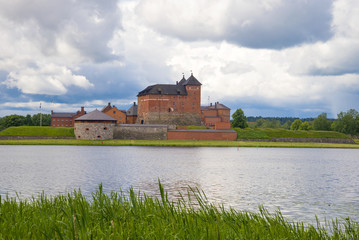 Naklejka na ściany i meble View of the ancient Hameenlinna fortress on a cloudy June day. Finland