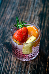 Fruit Cocktail with Strawberry, Mandarin, Apple and Rosemary / Fresh Pink Punch Beverage.