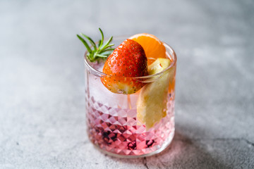 Fruit Cocktail with Strawberry, Mandarin, Apple and Rosemary / Fresh Pink Punch Beverage.