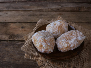 A Malay traditional dessert called Gagatas or Getas on right conner over wooden background 