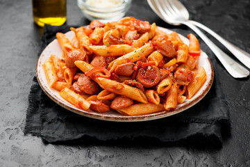 Penne Pasta with grilled sausage and tomato sauce served with parmesan cheese.