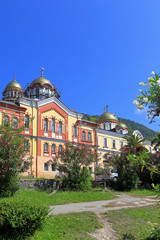 Fototapeta na wymiar Novoafonsky monastery among the mountains against the blue sky in the Republic of Abkhazia