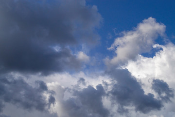 Naklejka na ściany i meble Grey cumulus clouds on blue sky before rain.