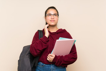 Fototapeta premium Young student Asian girl woman over isolated background thinking an idea