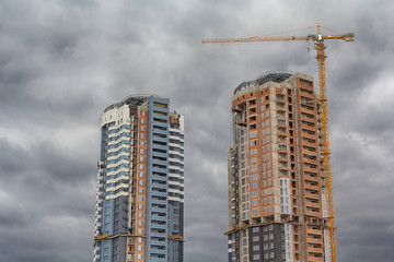 Fototapeta na wymiar Crane and building under construction against sky