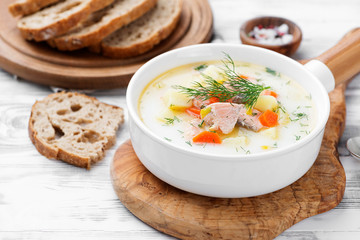 Creamy soup with  salmon, potatoes, carrots and dill. Healthy food.