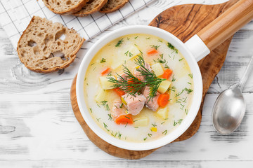 Creamy soup with  salmon, potatoes, carrots and dill. Healthy food.