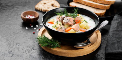 Creamy soup with  salmon, potatoes, carrots and dill. Healthy food.