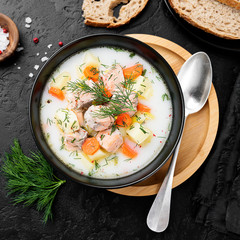 Creamy soup with  salmon, potatoes, carrots and dill. Healthy food.