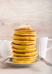 Pile of beer pancakes and piece of butter