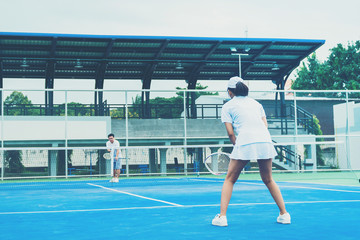 Sport concept; Young people playing tennis on court and relaxing of sport