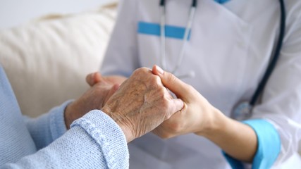 Doctor Keeping Hands Of Senior Patient. Closeup. Health Care/Medical Assistance.