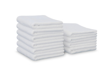 Stack of white plush hotel towels isolated on white background