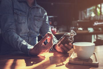 businessteam relaxing and talking in nightclub ; businessman drinking beverage in counter at nightclub