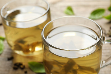 Cups of delicious fresh green tea on table, closeup