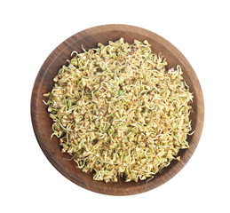 Wooden plate of sprouted green buckwheat isolated on white, top view