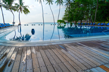 Private oceanfront pool with submerged loungers in a luxury reso