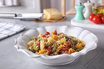 Delicious colorful pasta on light grey table