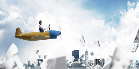 Businessman in aviator hat driving plane © adam121