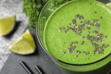 Tasty kale smoothie with chia seeds on table, closeup