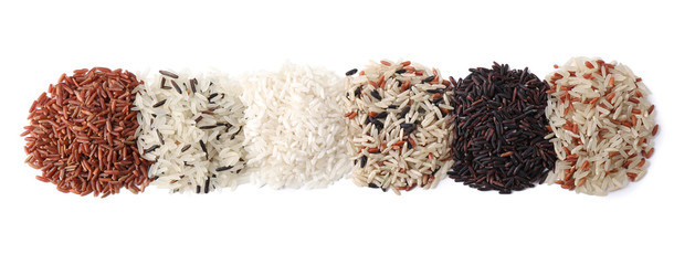 Different types of brown and polished rice isolated on white, top view