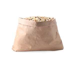 Mix of brown rice in paper bag isolated on white