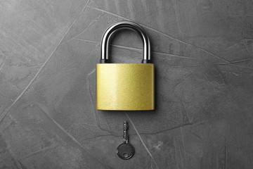Steel padlock and key on grey background, top view. Safety concept
