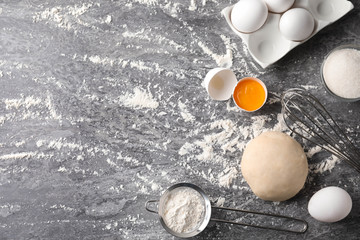Flat lay composition with dough on grey table, space for text. Cooking pastries