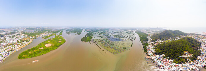 Aerial view Ha Tien city skyline from above, Mekong river delta, South Vietnam. Scenic river water...