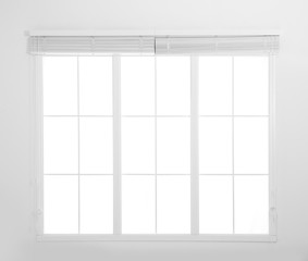 Window with white open blinds in room