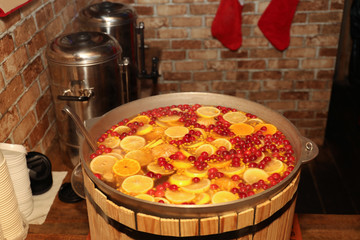 Large cauldron with tasty mulled wine at winter fair