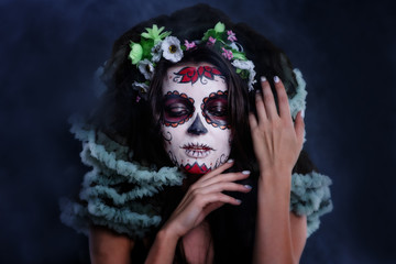 Young woman with sugar skull makeup. Dia de los muertos. Day of The Dead. Halloween costume and make-up. Portrait of Calavera Catrina