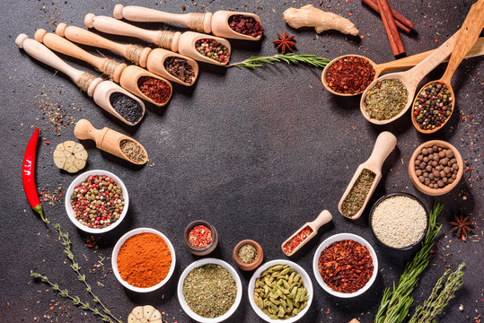 Spices and herbs over black stone background. Top view with free space for menu or recipes © chernikovatv