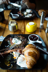 Morning Breakfast plate healthy cute eggs with hash brown and croissant jam poached eggs  vertical photo