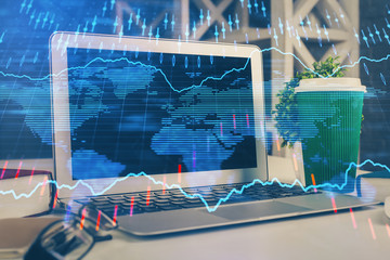Financial market graph hologram and personal computer on background. Multi exposure. Concept of forex.