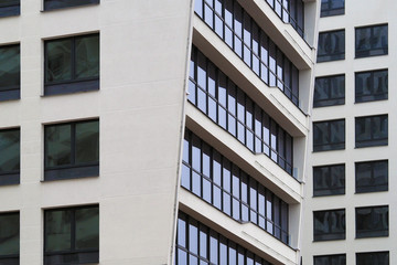 The windows of a multistory building are angled. fragment of a multi-storey residential building