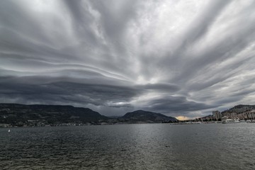 Crazy wild clouds over lake in Canada with storm thunder coming and windy day 