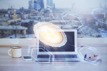 Double exposure of blockchain theme hologram and table with computer background. Concept of bitcoin crypto currency.