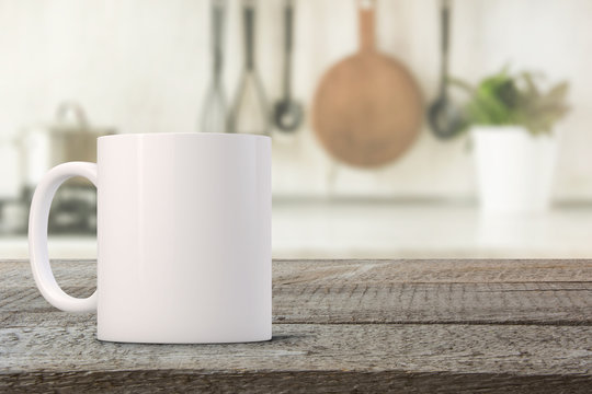 White coffee Mug Mockup set-up in a kitchen, with blurred background. Great for overlaying your custom quotes and designs for selling mugs.