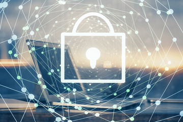 Double exposure of desktop with computer and lock icon hologram. Concept of data safety.