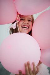 Fototapeta na wymiar portait of happy young girl with pink balloons