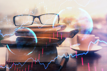 Financial graph hologram with glasses on the table background. Concept of business. Double exposure.