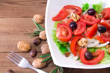 Vegetable salad with nuts and olives, diet and health concept